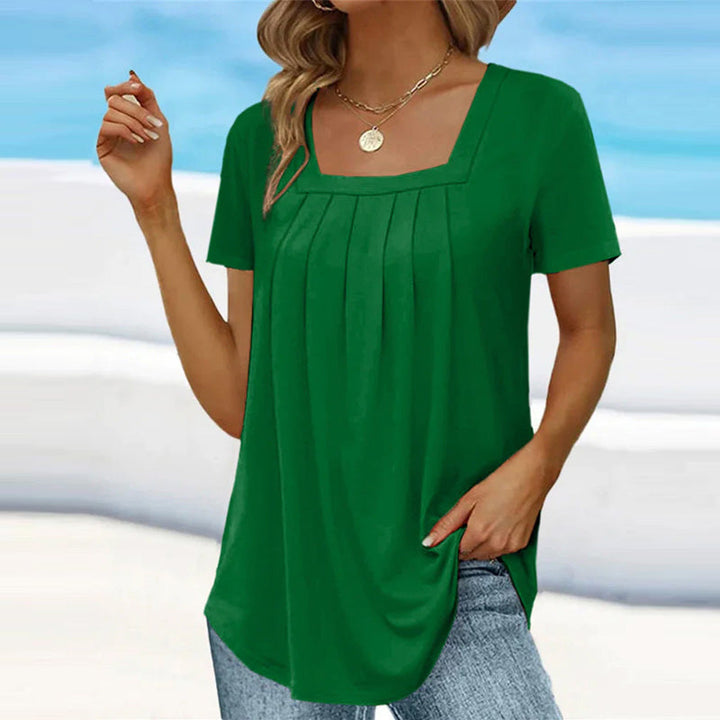 Camicetta da donna alla moda con maniche corte ed elegante scollatura quadrata