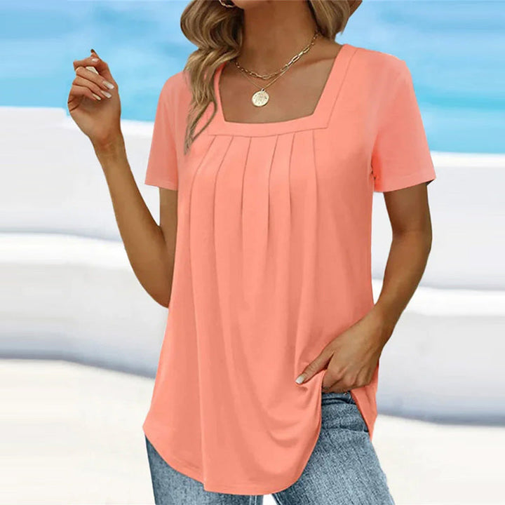 Camicetta da donna alla moda con maniche corte ed elegante scollatura quadrata