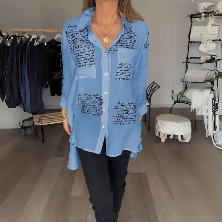 <p>Noëlla - Blusa Artistica Unica con Stampa Scritta a Mano Elegante</p>