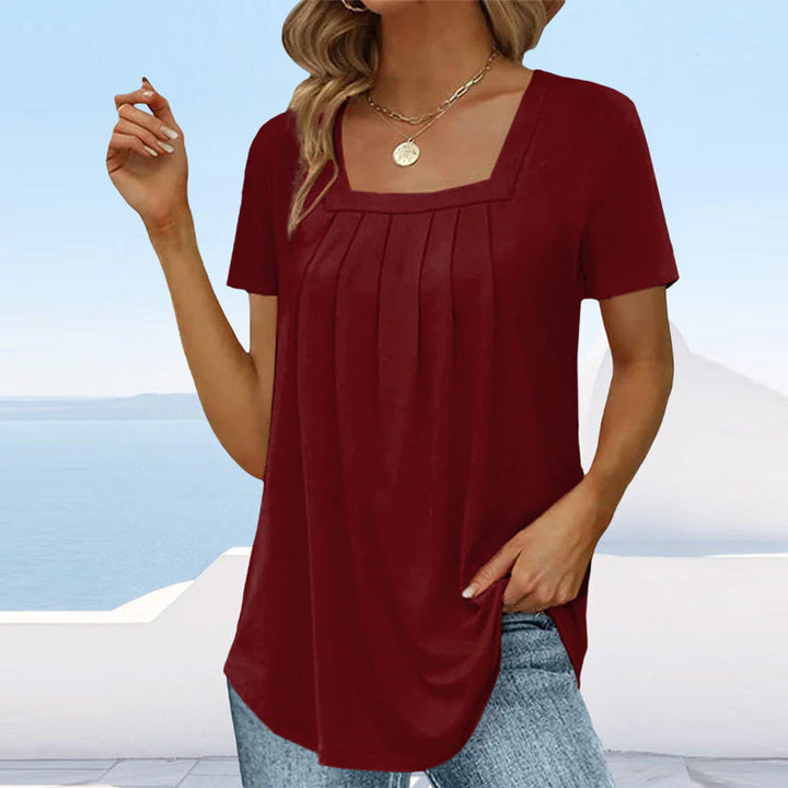 Camicetta da donna alla moda con maniche corte ed elegante scollatura quadrata