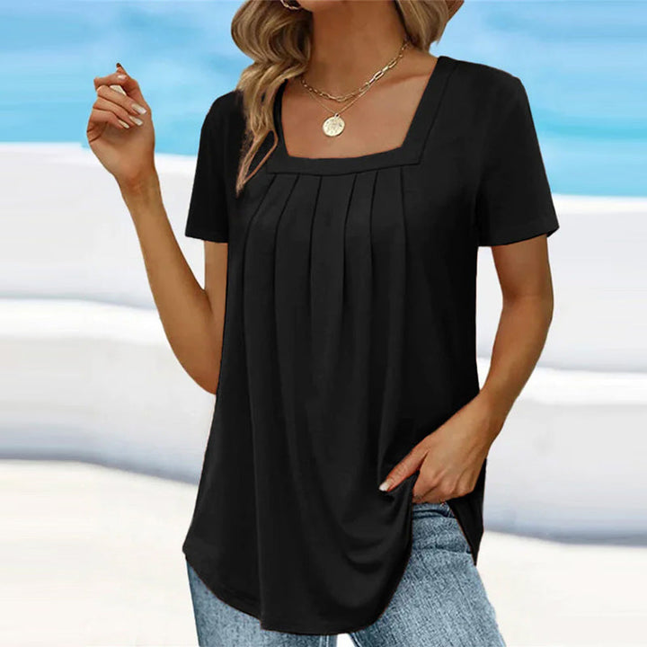 Camicetta da donna alla moda con maniche corte ed elegante scollatura quadrata