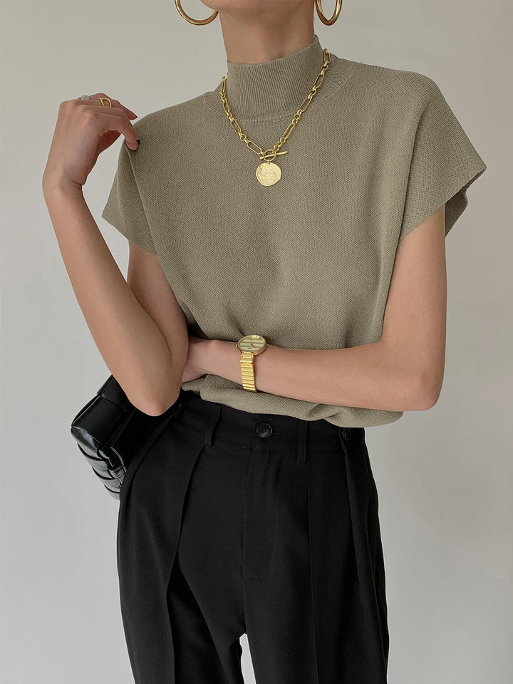 <html><body><p>Ismara - Top Elegante con Collo Alto Chic</p></body></html>