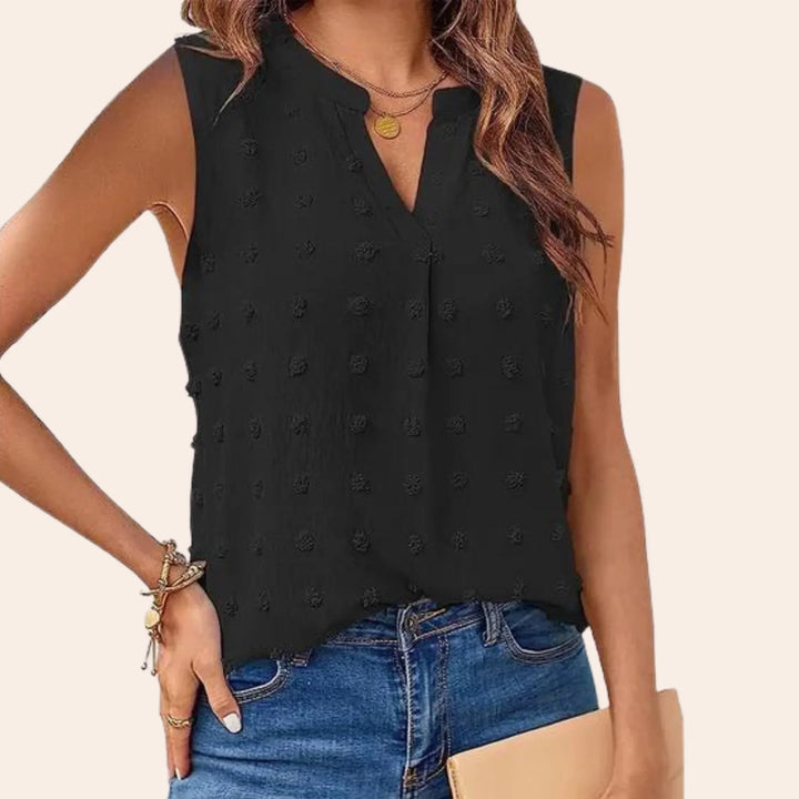 Elegante camicetta da donna senza maniche con motivo a pois di tendenza e attraente scollatura a V