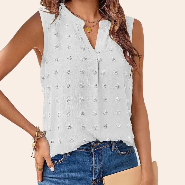 Elegante camicetta da donna senza maniche con motivo a pois di tendenza e attraente scollatura a V
