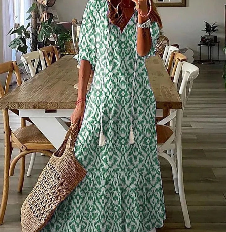 <html><body><p>Lilly - Elegante maxi dress con stampa floreale e maniche a metà con scollatura a V</p></body></html>